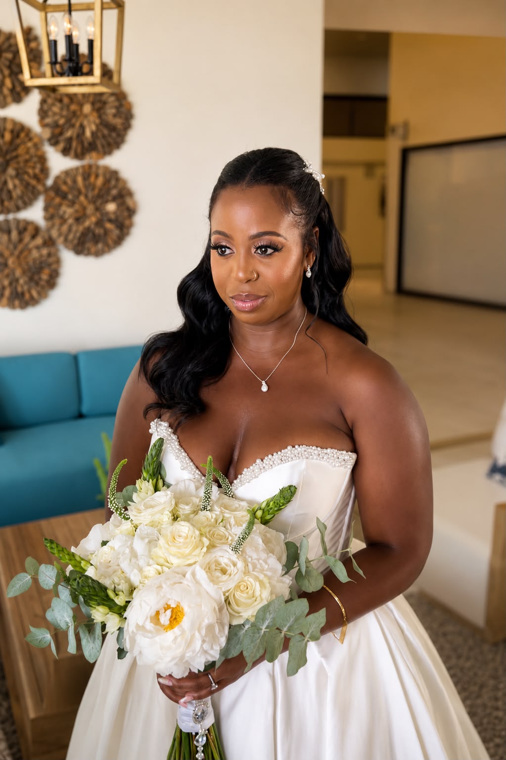 Bride with a half-up curled style holding a white rose bouquet